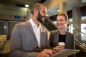 Businesspeople discussing over digital tablet at airport