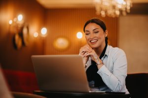 Radiant Latina businesswoman confidently leads business meeting over coffee.