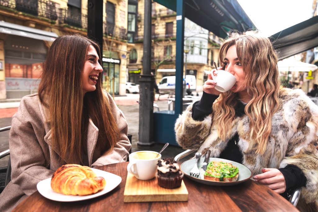 two-friends-having-breakfast-terrace-winter-morning-donostia-san-sebastian-basque-country