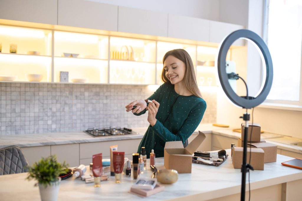 Girl in neutral photo, where can see packaging of cosmetic